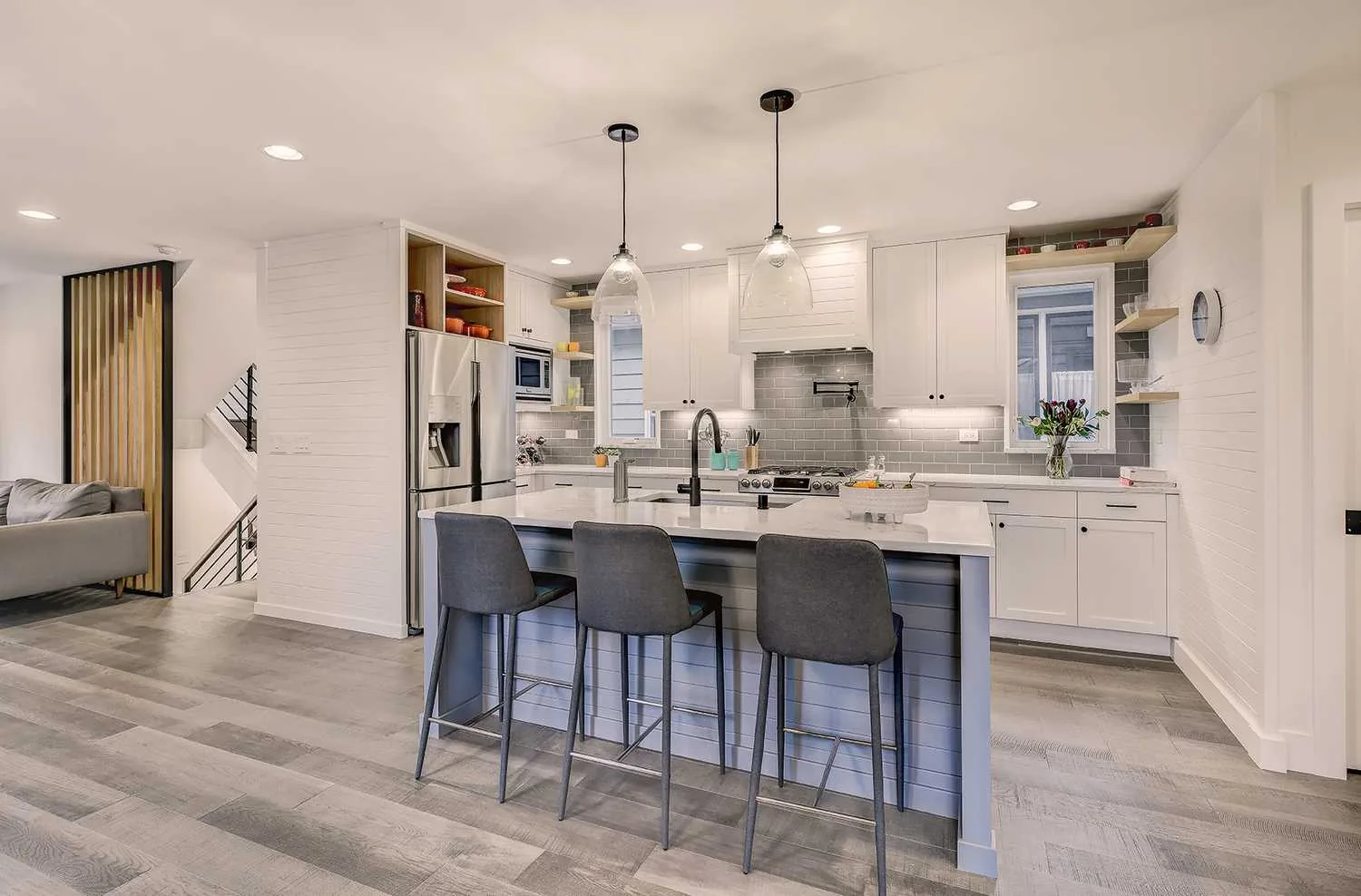Two-tone cabinets refinished by Hedlund Painting in a Green Lake, Seattle kitchen: white perimeter cabinets and blue island.